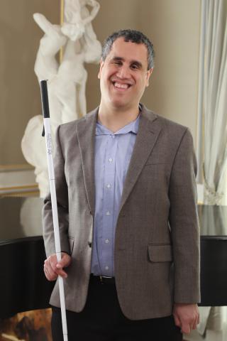 Dr. Cary Suppalo holding a whitecane