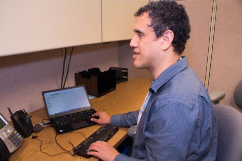 Dr. cary Suppalo sitting a computer desk